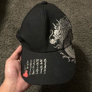 Black Hat with dragon print along the side and symbols on the front